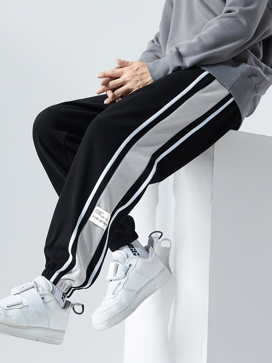 Men's loose sports pants for summer and fall, trendy style, available in large sizes, suitable for casual wear.