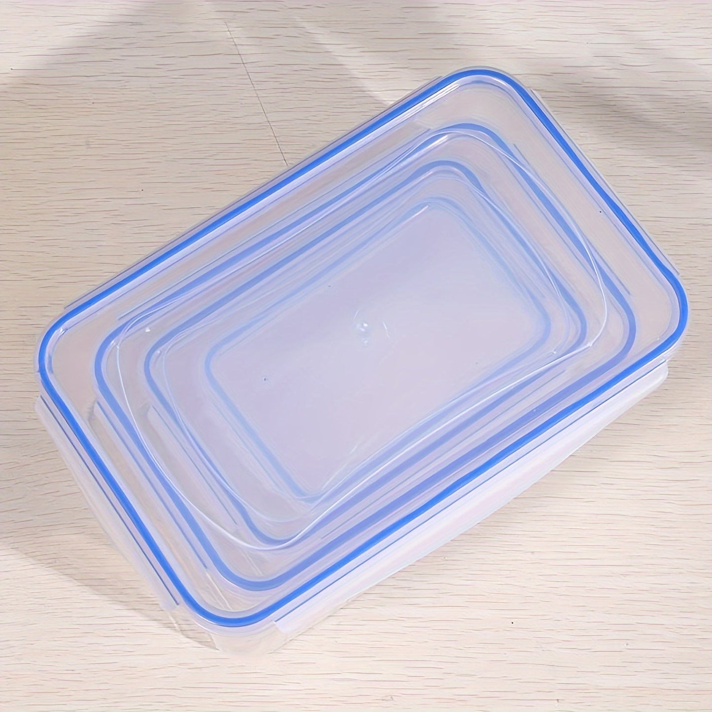 Transparent plastic food storage box with moisture-proof and airtight seal, ideal for storing grains and other foods in the kitchen refrigerator. This large container is microwave safe and thickened for durability, making it a must-have accessory for