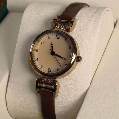 Elegant vintage-inspired women's watch with quartz movement and synthetic leather strap, non-rechargeable button battery.