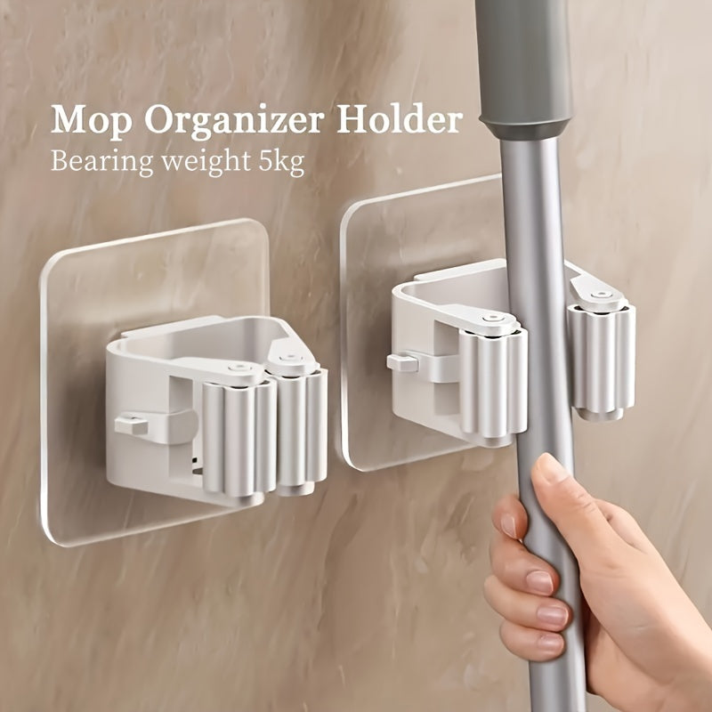 Wall-mounted holder for mops and brooms with easy installation and strong adhesive. Ideal for home organization and storage of cleaning tools.