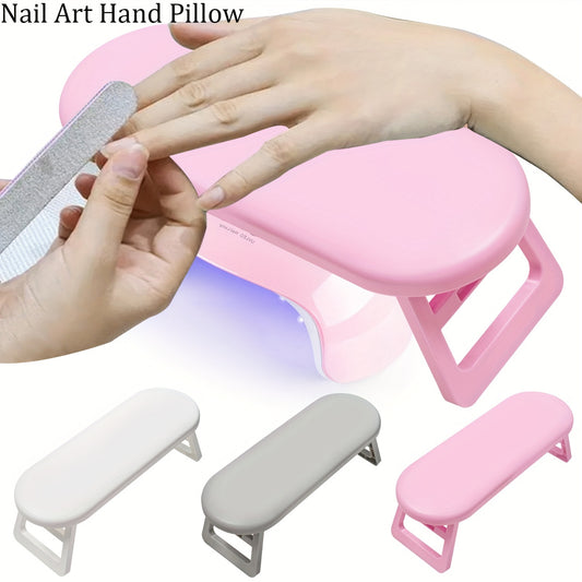 Foldable, portable hand rest for nail art technicians to increase efficiency.