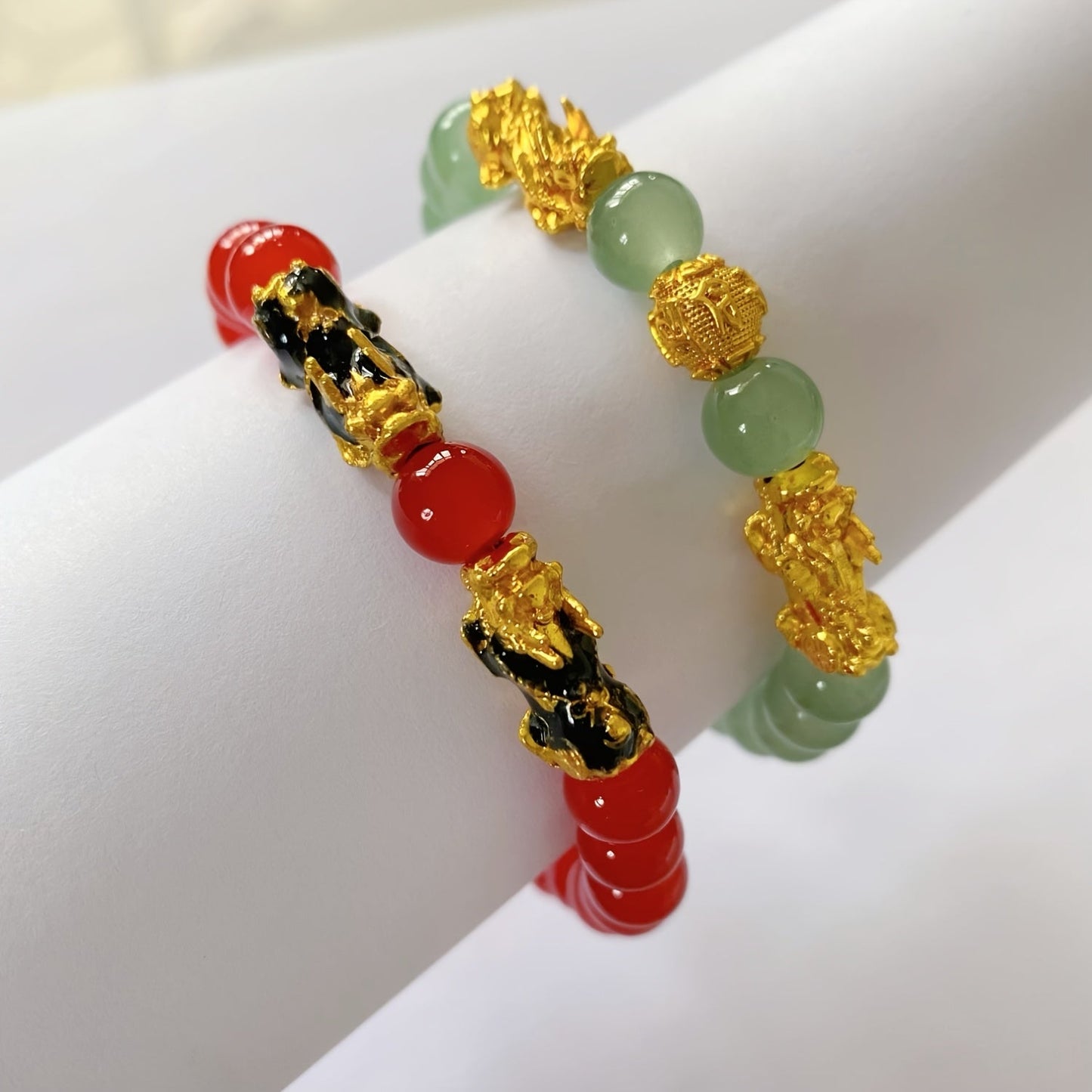 Two Pixiu bracelets, one in red antique style, offering a safe and lucky accessory. This classic, luxurious piece symbolizes prosperity and is beautifully crafted with shiny, artificial jewels. Perfect for gifting to girlfriends, sisters, or mothers to