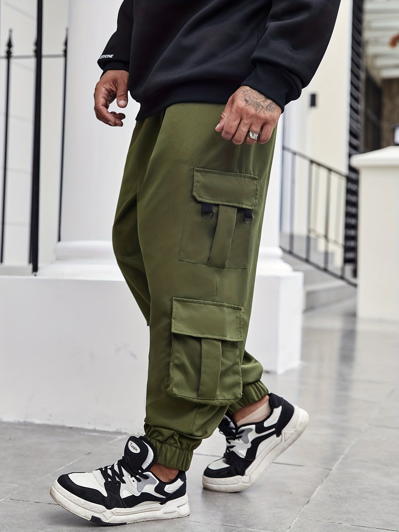 Men's plus size cargo pants with pockets for spring and fall fashion.