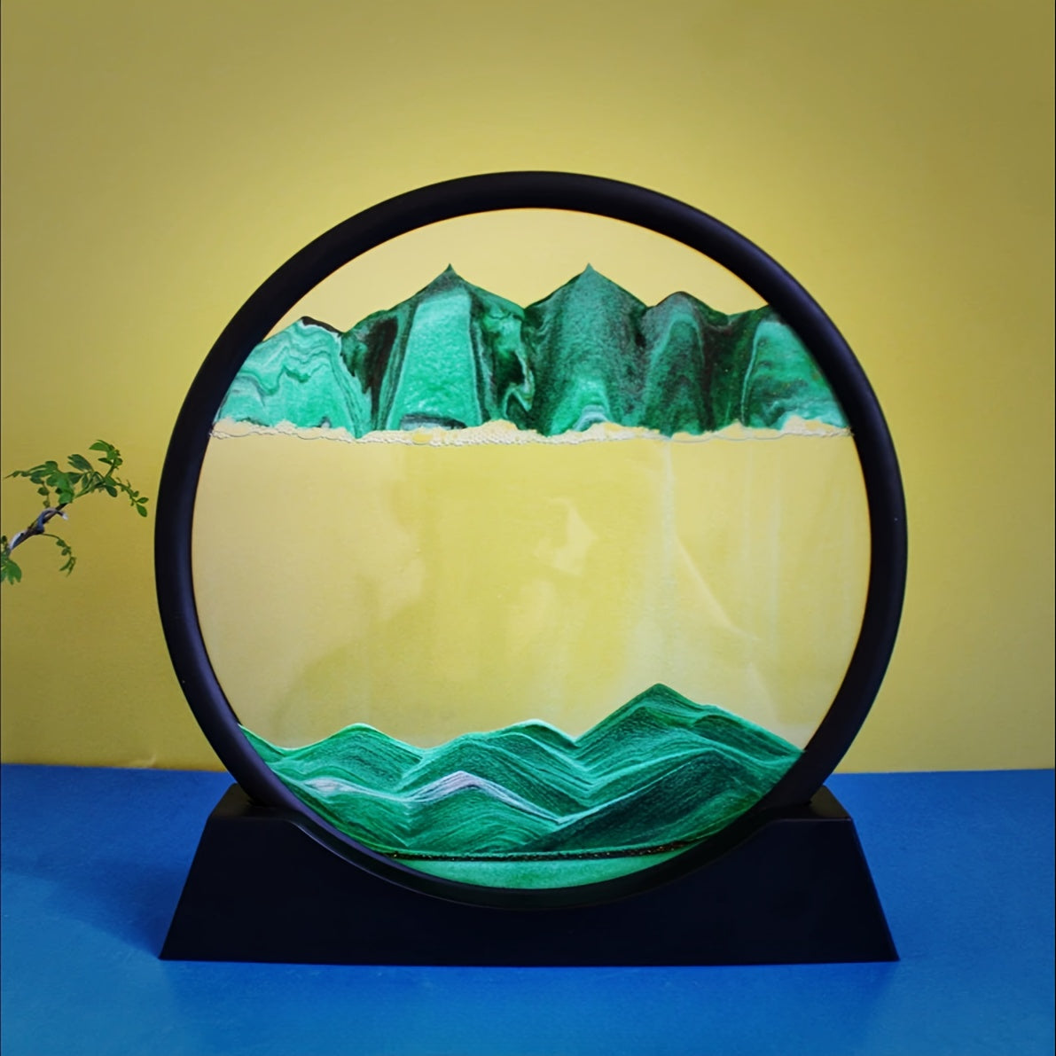 Large round glass frame with flowing sand creates a 3D deep sea scene as a relaxing home and office decoration.