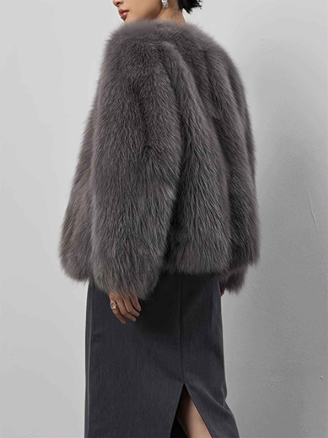 Stylish women's coat in light gray faux fur with fluffy collar, perfect for cold weather