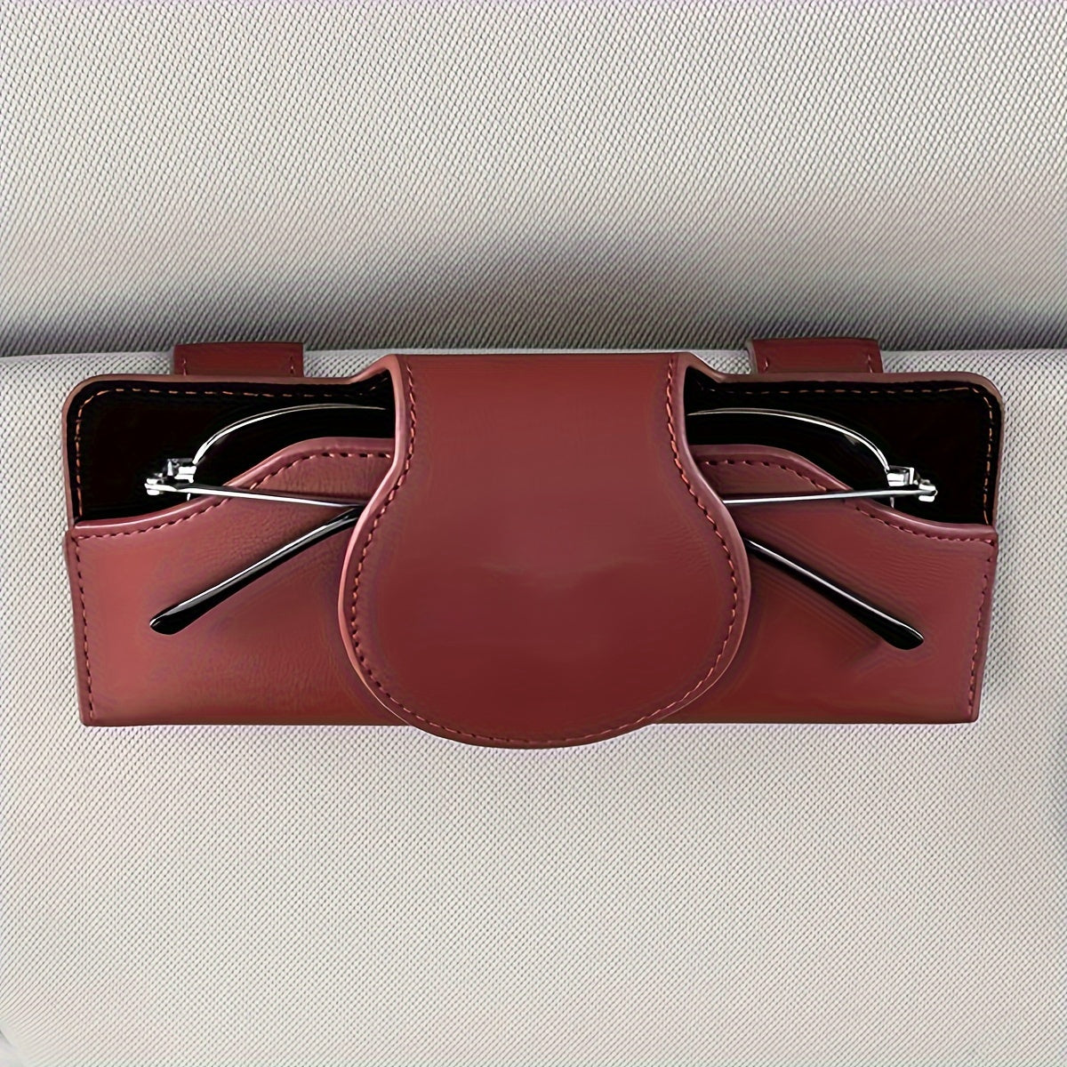 Car visor glasses holder with magnetic closure, PU leather eyeglasses storage clip, vehicle sun visor organizer with strong adsorption.