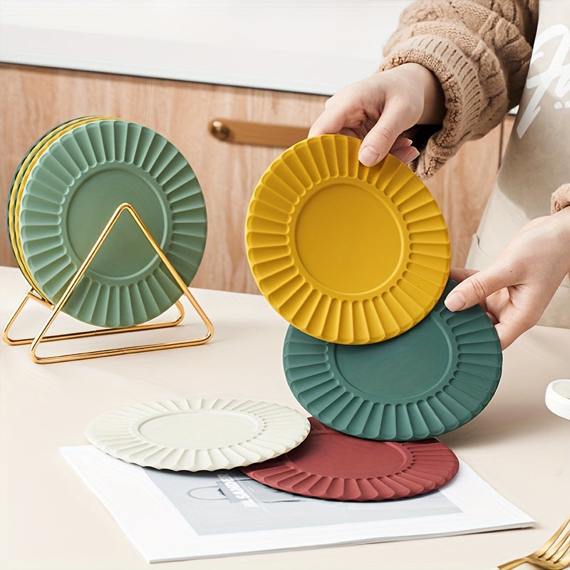 Set of 6 silicone cup coasters with a round sunflower design and metal holder, perfect for protecting your kitchen table from heat. These heat-resistant mats can also be used as dining placemats or pot pads. Includes 1 holder and 5 coasters.