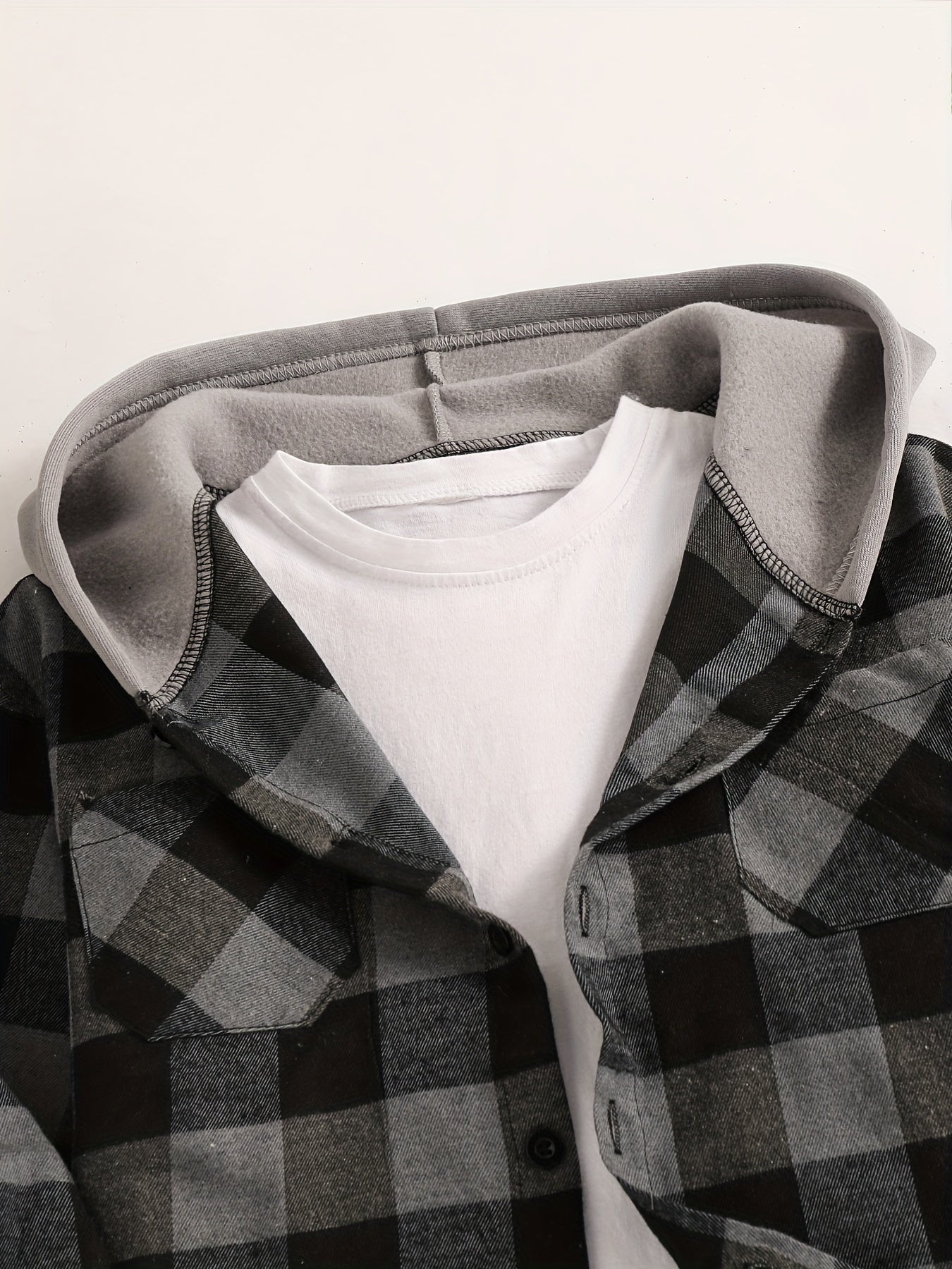 Boys' plaid hooded shirt in blue and black with flap pockets, made of cozy polyester for fall/winter casual wear.