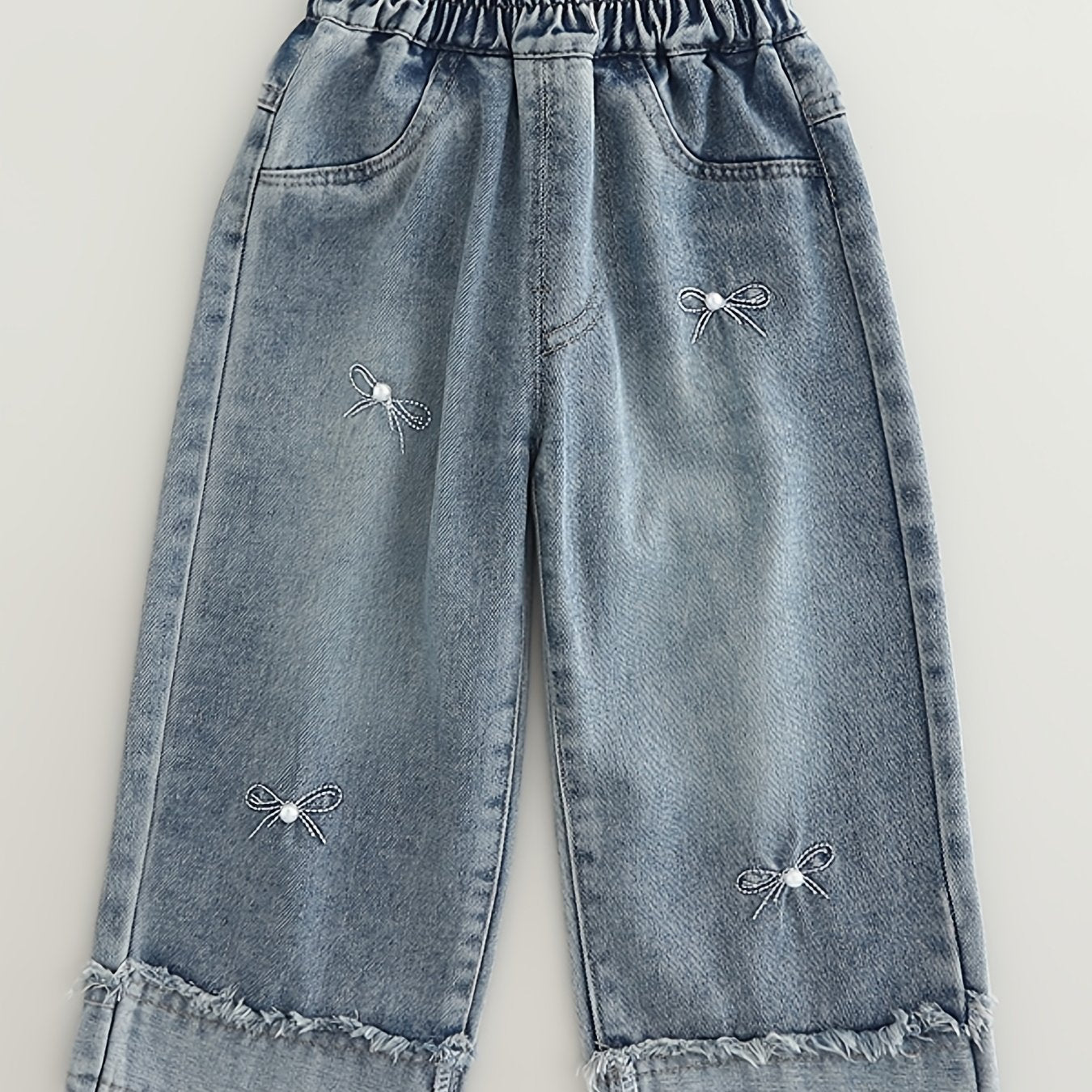 Fashionable loose-fit denim pants for girls, made of rayon blend in a solid color. Machine washable. Suitable for spring/autumn. Ideal for trendy babies. Features long pants.