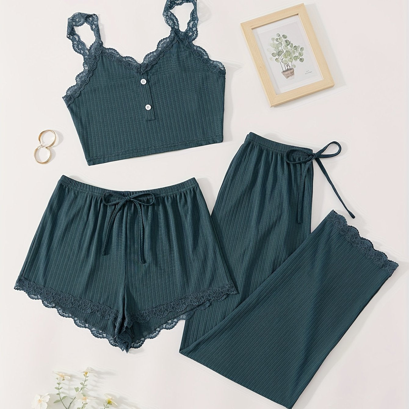 Three-piece set of women's ribbed fabric pajamas with suspender top and shorts.