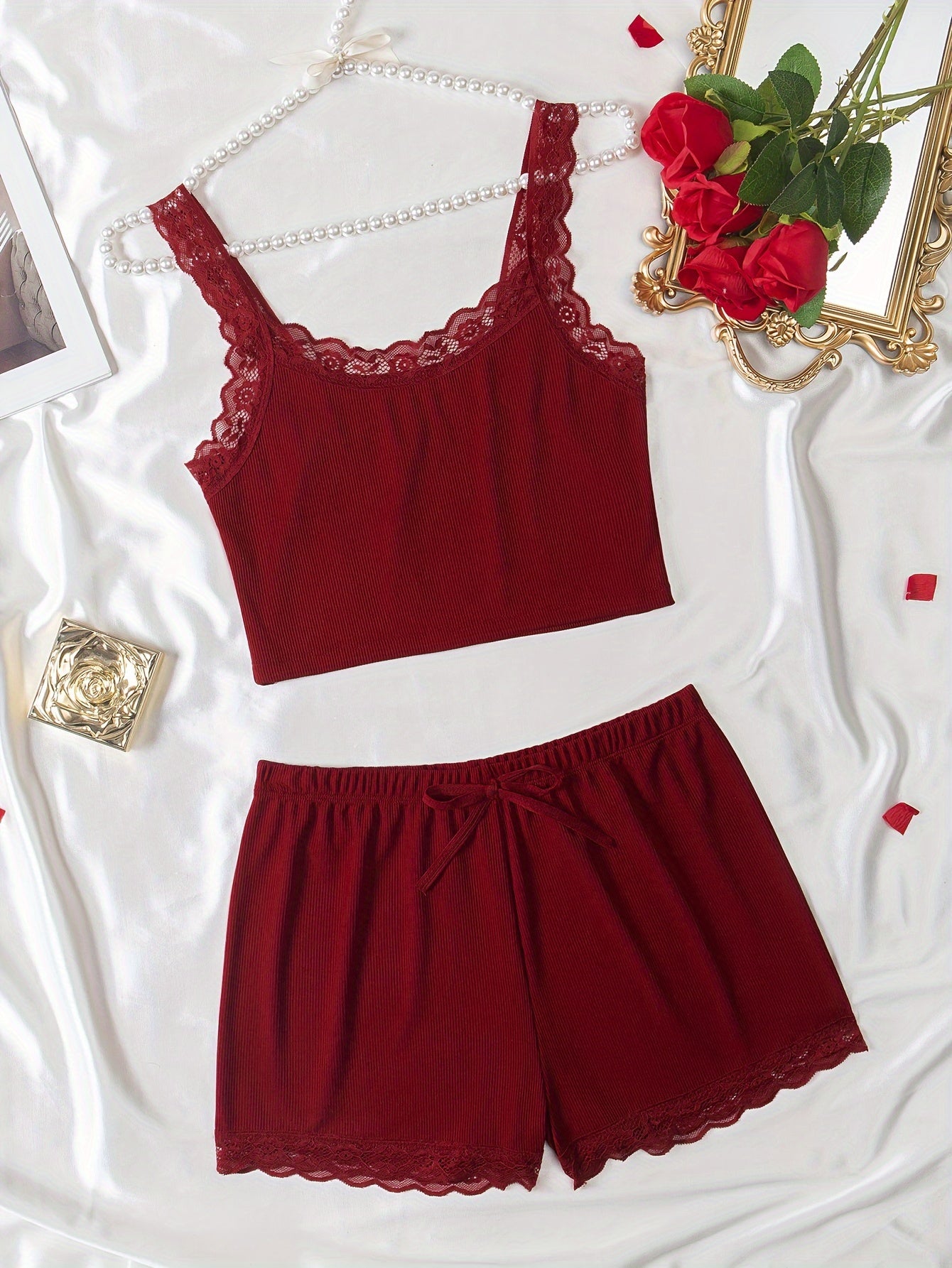 Women's loungewear set includes lace trim cami top and elastic waistband shorts.