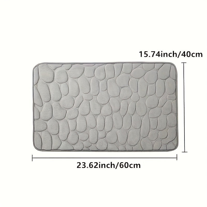 The Coral Fleece Non-Slip Bath Mat features a pebble design and is made of memory foam for ultimate comfort. This machine-washable bathroom rug has a solid pattern, flat woven construction, and low pile for easy care. It has a weight of 400gsm and comes