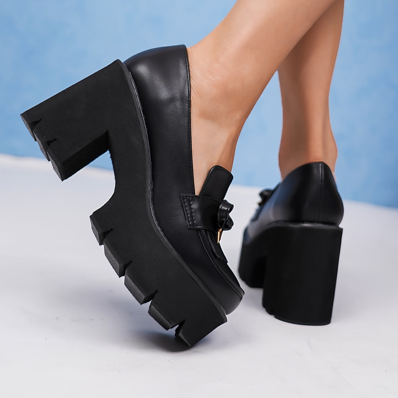 Black platform pumps for women with bow accent. Round toe, high heel shoes with lightweight rubber sole. All-season comfort with man-made materials.