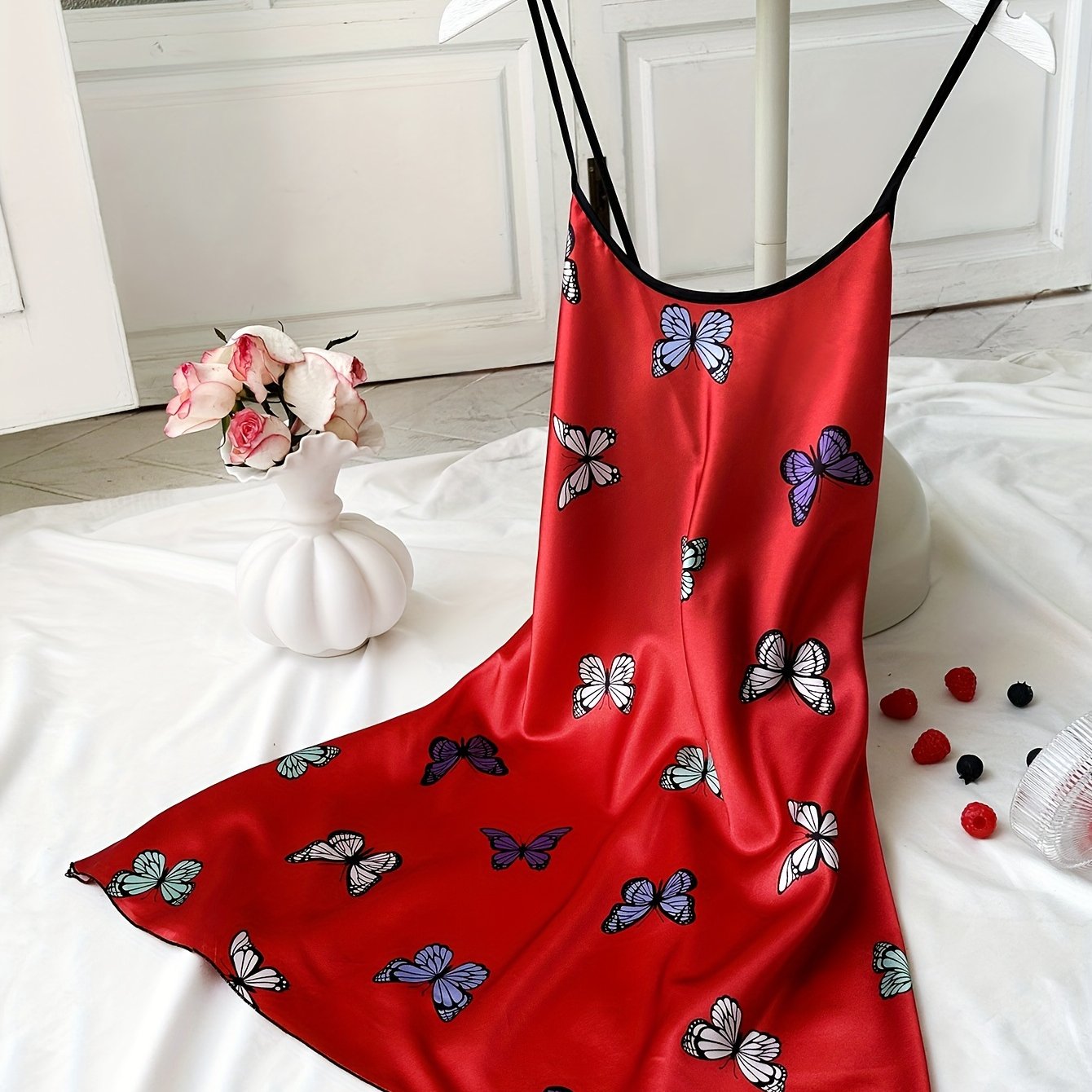 Satin nightgown with butterfly print and adjustable cross straps, perfect for women's sleepwear.