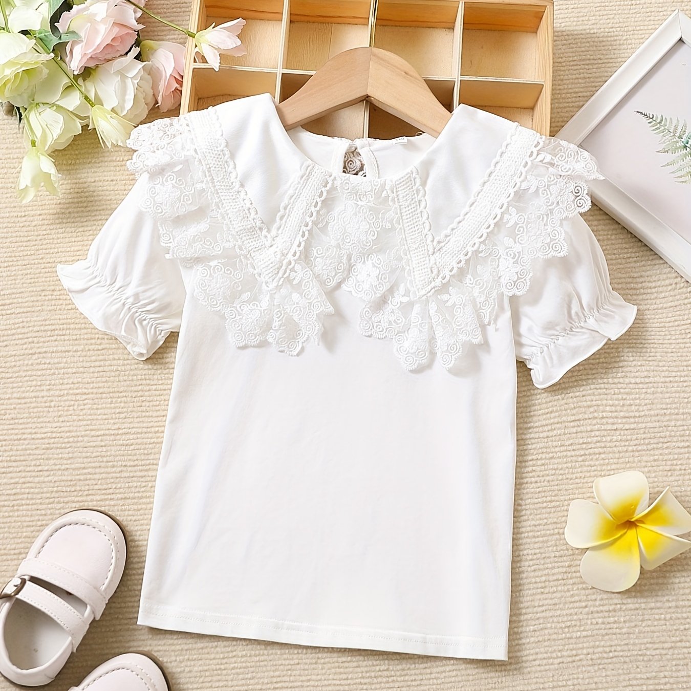 Girls' cotton knit T-shirt with lace collar detail, ideal for summer. Stretchy, breathable, and machine washable.