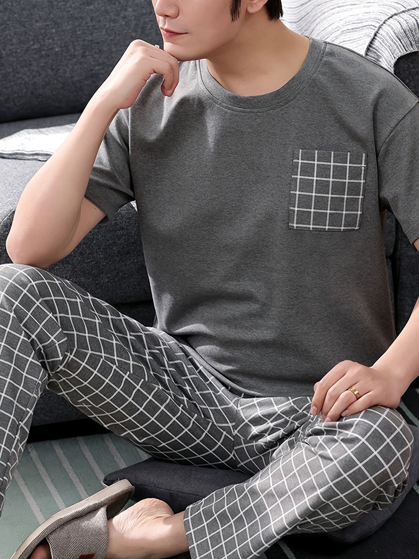 Men's 2-piece plaid pajama set includes round neck top and matching trousers for cozy loungewear comfort.