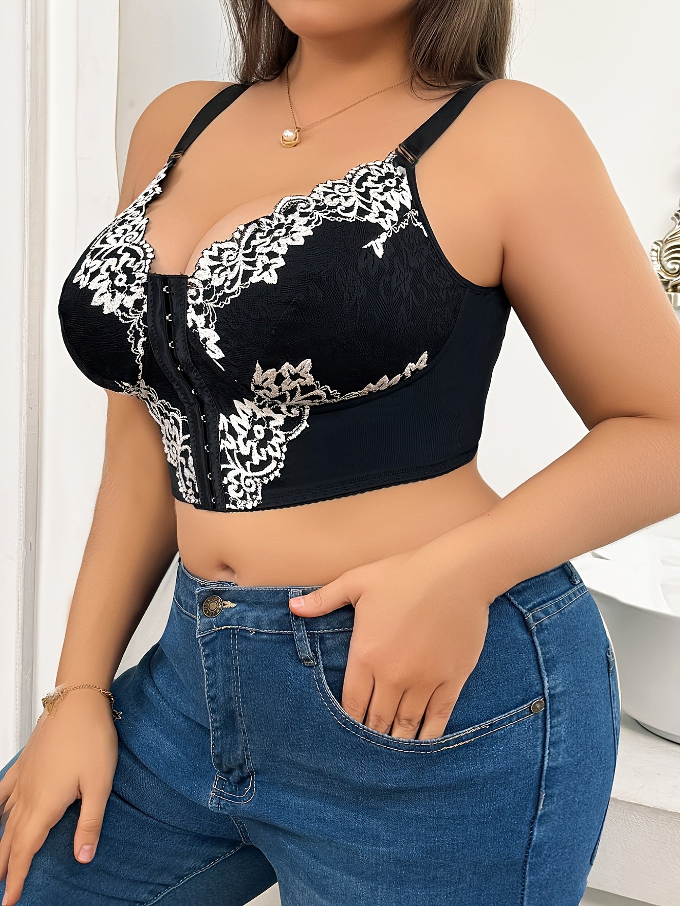 Plus size lace front-closure bra with floral print and contrasting lace detail, wide shoulder straps for comfort. Hand washable fabric in black and white.