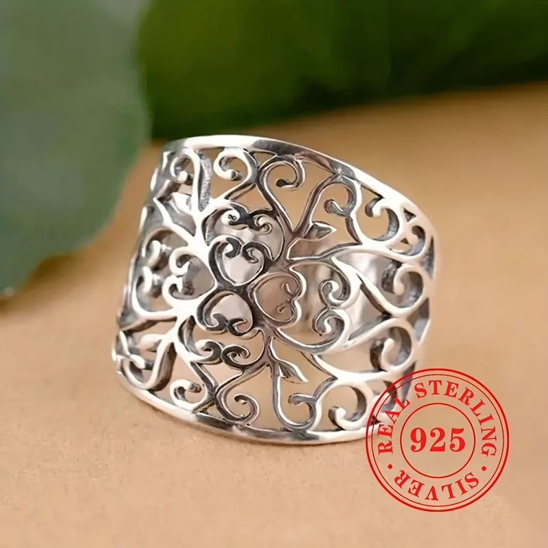 This elegant and one-of-a-kind lady's ring is crafted from high-quality S925 sterling silver, weighing 5.7 grams. It showcases a stunning hollowed-out floral vine design on the wide face, highlighting the exquisite craftsmanship behind its creation.