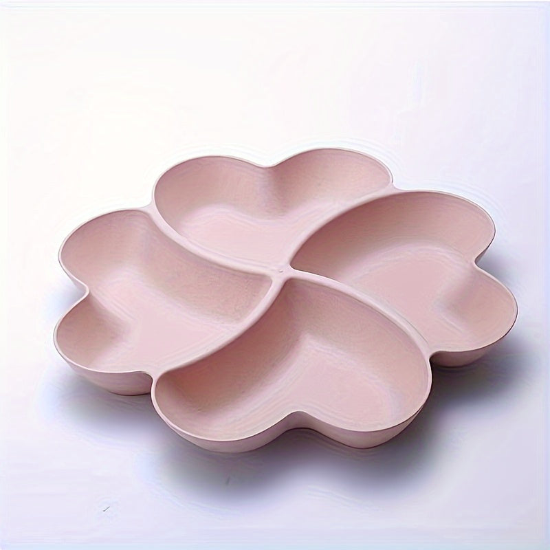 Heart-shaped party snack tray with 4 compartments, perfect for serving nuts, candy, fruit, and other snacks. Made of reusable plastic in blue, green, beige, and pink colors.