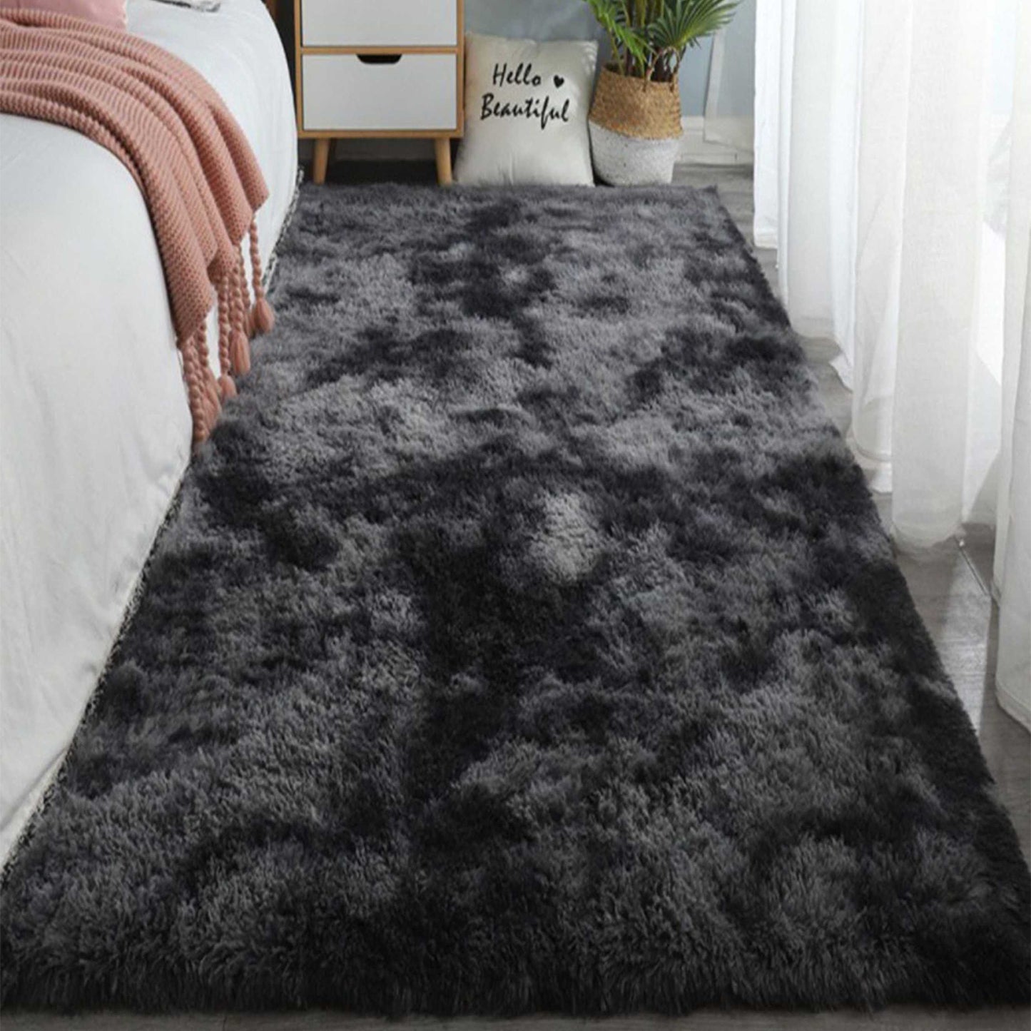 One piece of plush, fluffy area rug designed for bedrooms. This soft, fuzzy shaggy rug is black in color and rectangular in shape, perfect for adding warmth to your living room. It features a non-slip bottom to ensure safety. Great for Halloween or