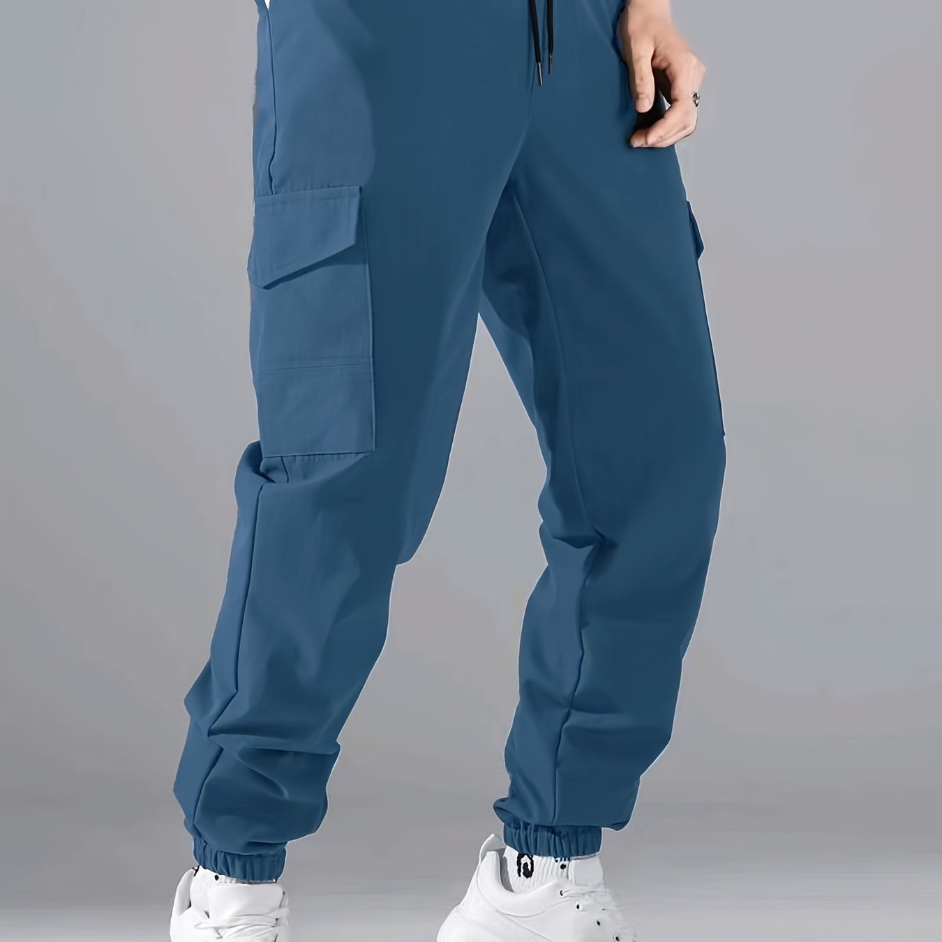 Men's casual joggers made of 100% polyester with a solid color, all-season, non-stretch fabric in a regular fit with pockets.