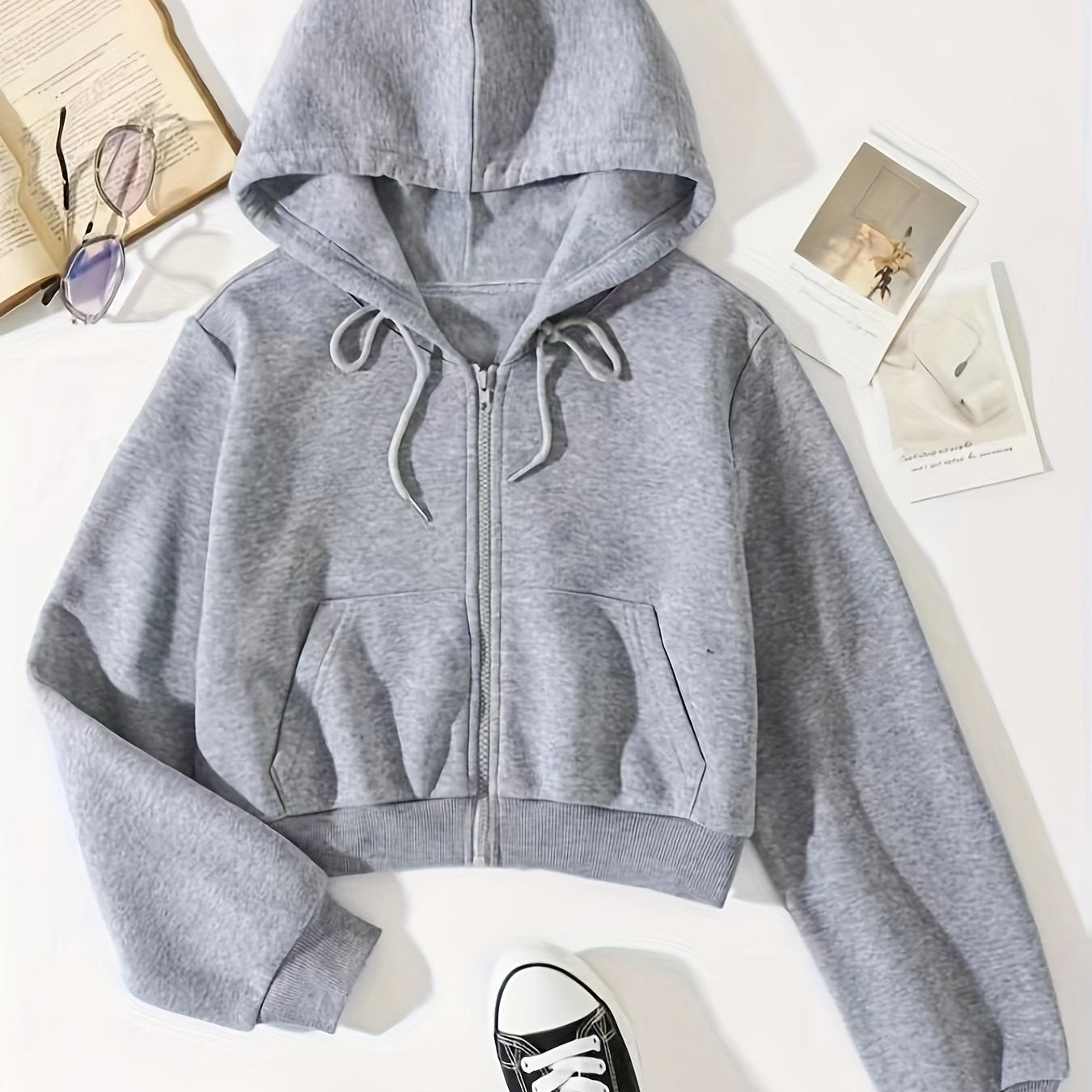 Drawstring zip-up crop hoodie with thermal lining and long sleeves, featuring a front pocket.