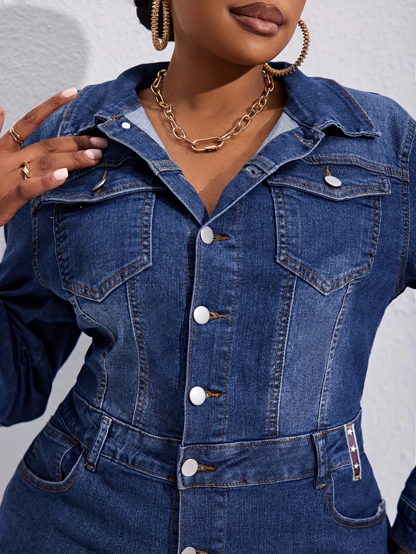 Kiki Angel offers a plus-size denim midi dress with a button-front, lapel collar, and frayed hem. Made from a cotton blend fabric, this solid color tunic is perfect for casual style in