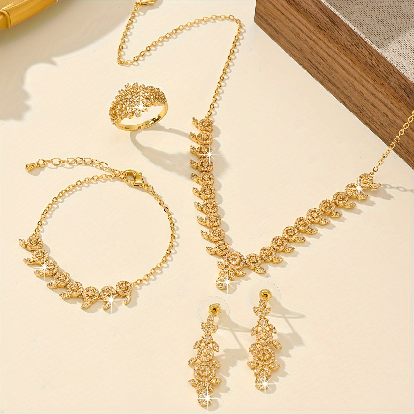 Luxurious Floral Jewelry Set featuring 5 pieces, made with 18K Gold Plated Copper, adorned with Synthetic Zirconia stones in a Leaf and Teardrop design. This set includes a Necklace, Bracelet, Earrings, and an Adjustable Ring, perfect for Women to wear