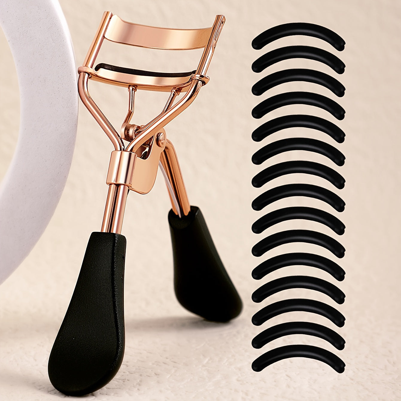 Portable eyelash curler with stainless steel handle, 15 silicone pads for curling and shaping without damaging lashes. Ideal for lifting and creating big, beautiful eyes on women.