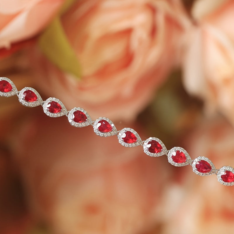 Stylish Sterling Silver Bracelet with Synthetic Red Gemstones and Celestial Theme, featuring zirconia Mosaic. This 925 Silver Plated Jewelry makes a perfect gift for December birthdays, special occasions, or Valentine's Day. A versatile fashion accessory