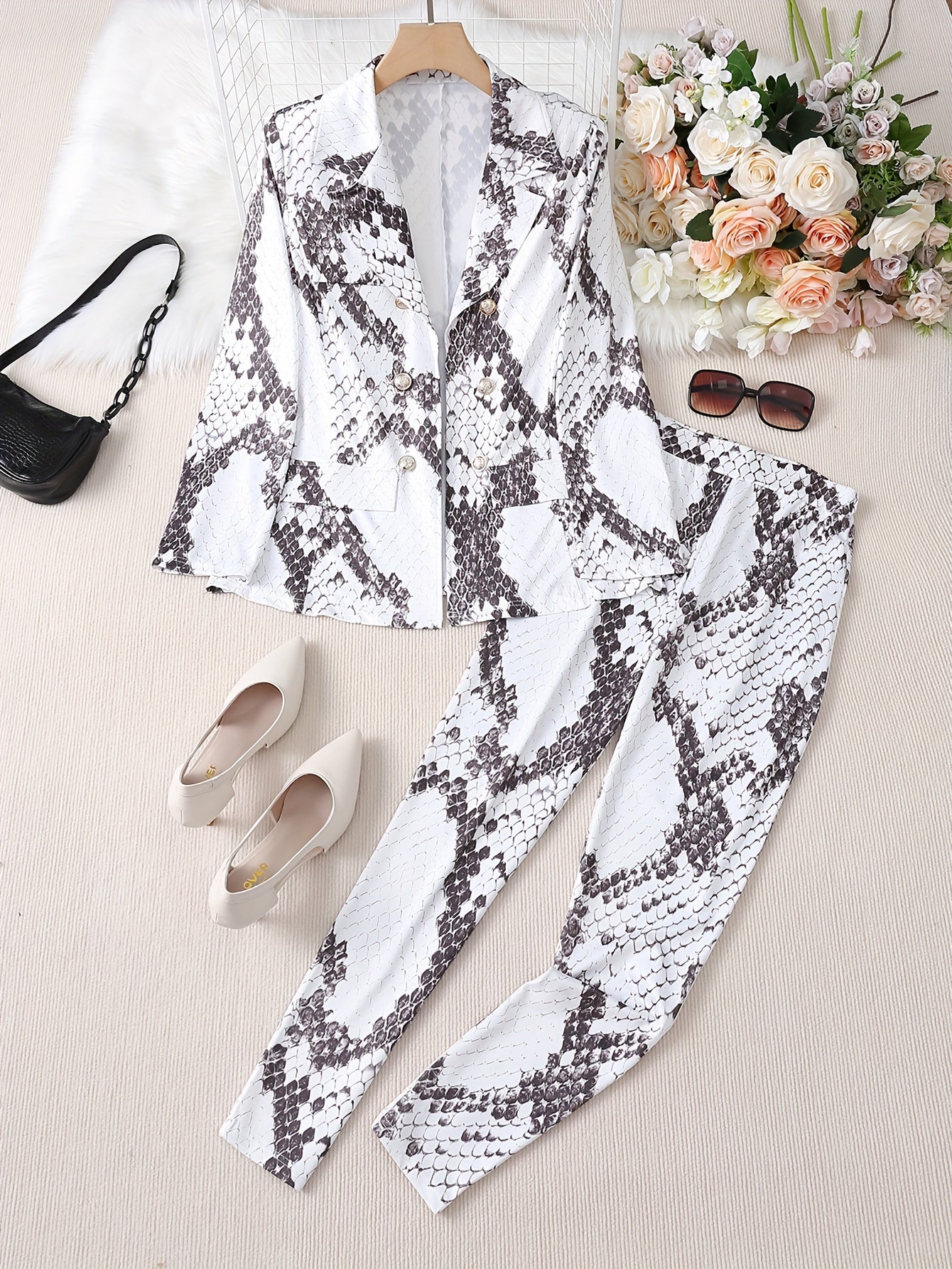 Snakeskin print two-piece set with blazer and pants for women.