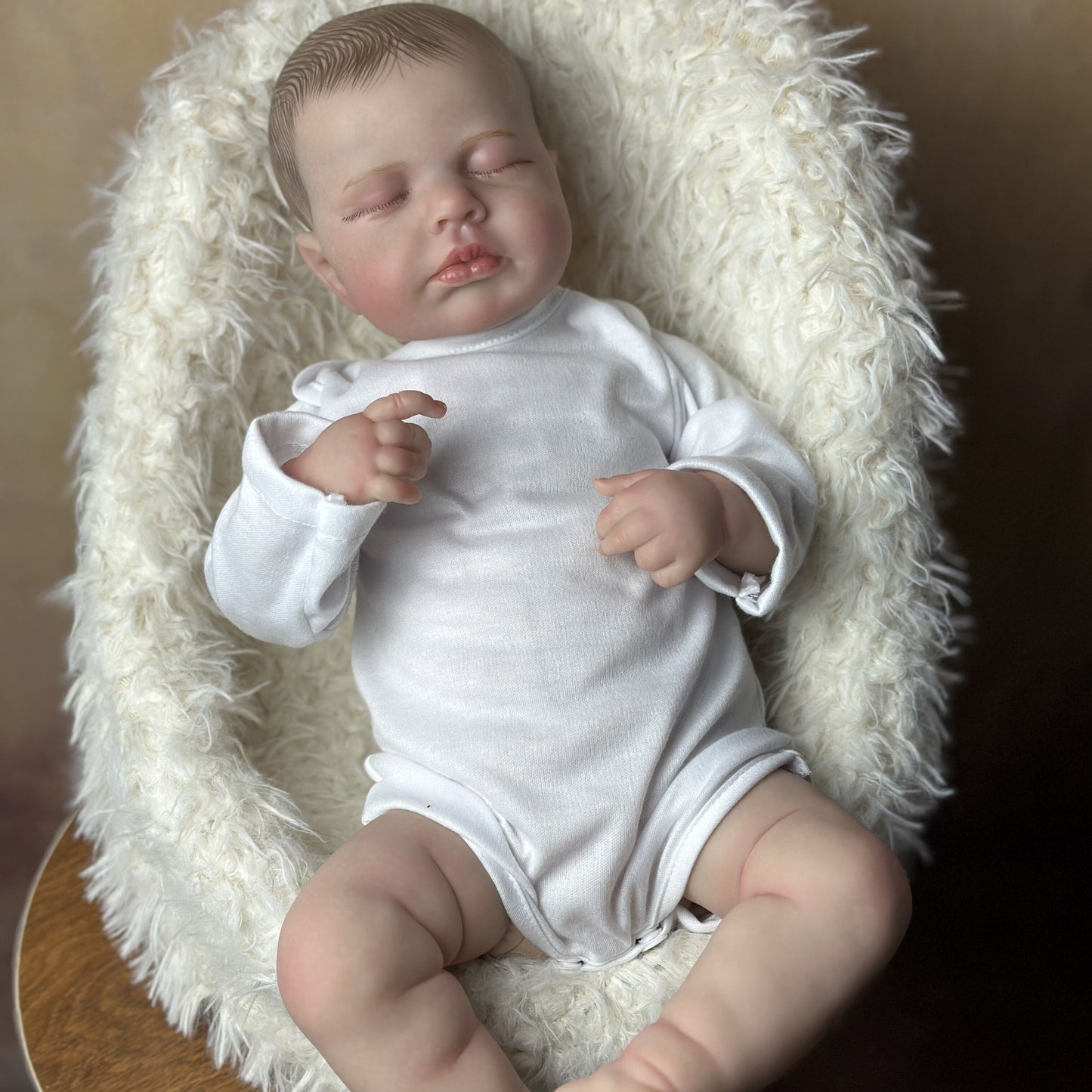 Realistic 20-inch Reborn Baby Doll with soft vinyl limbs, cloth body, and lifelike features.