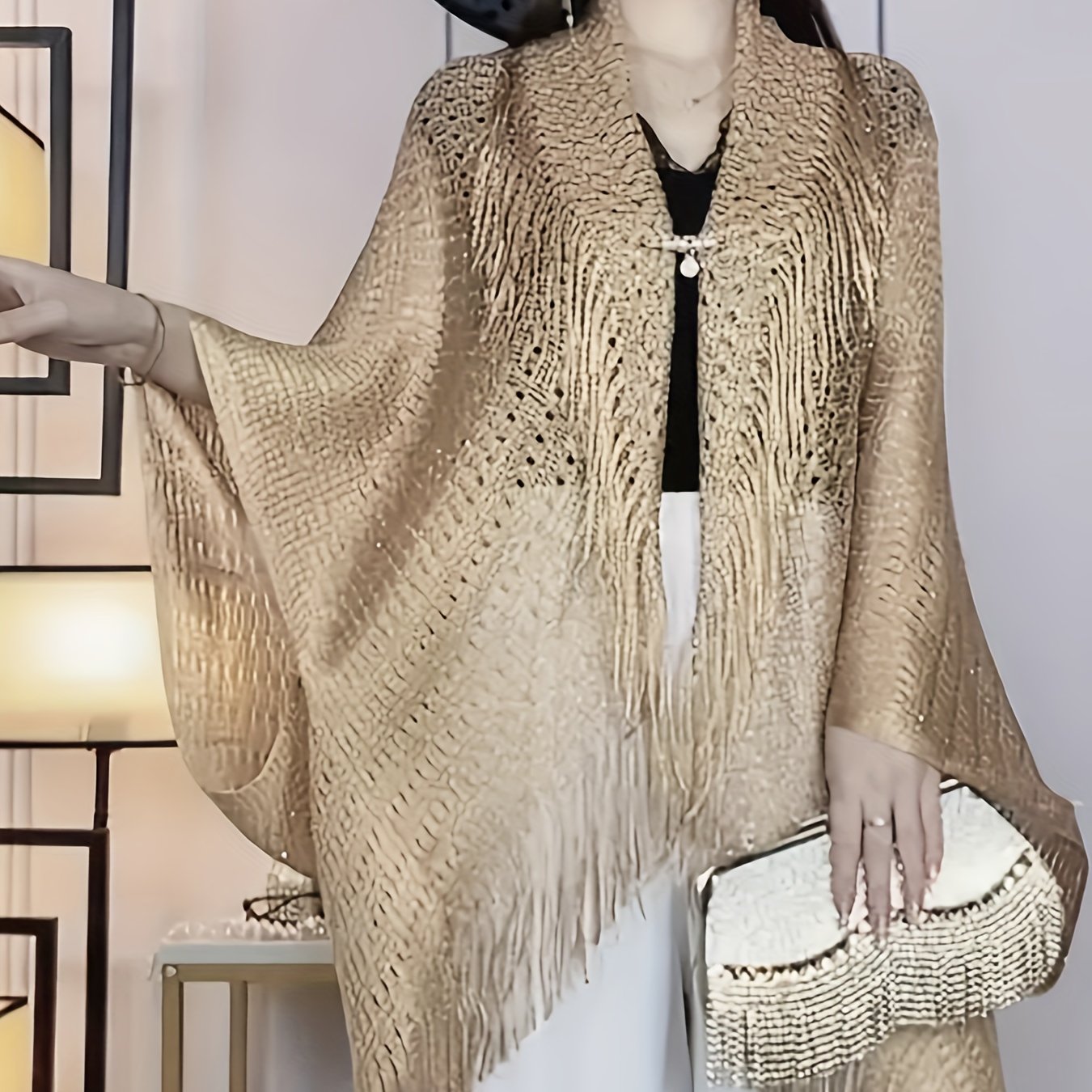 Stylish plus-size cardigan with tassel details, hollow-out design, and sun protection shawl. Made of polyester - hand or dry clean only.