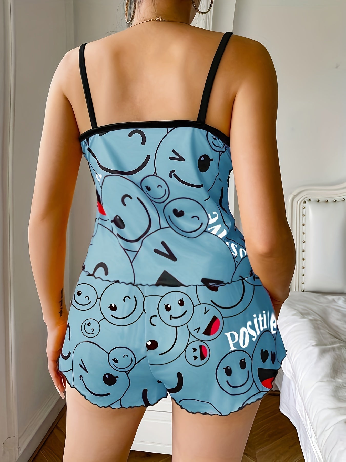 Women's sleepwear set with smiling face print cami top and elastic shorts.