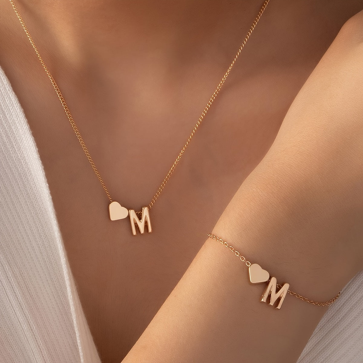 Chic two-piece set with metal heart and letter necklace and bracelet, ideal for daily wear.