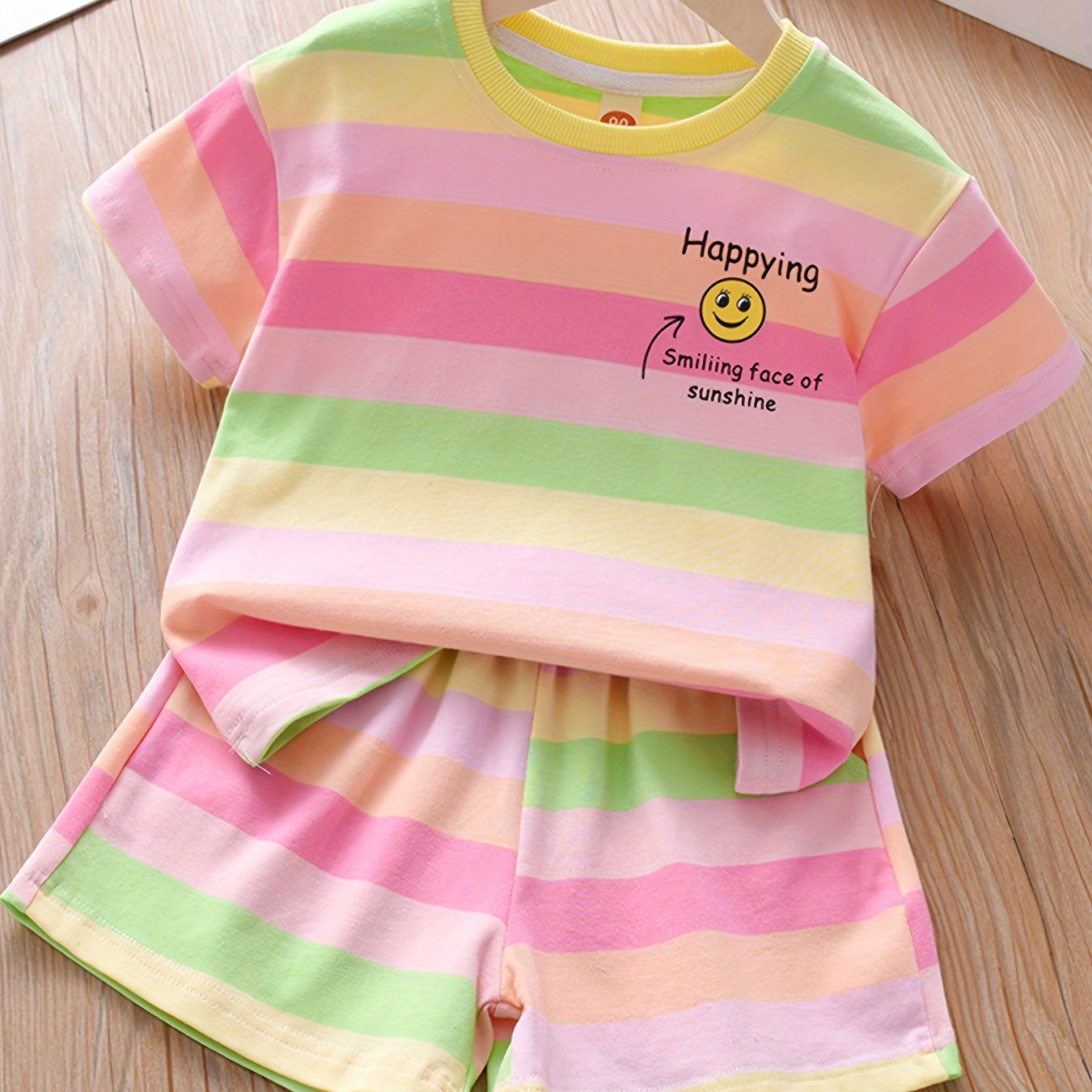 Summer fashion set for girls: Cute T-shirt with joyful face & letter print paired with striped shorts. Made of cotton blend, machine washable, ideal for outdoor activities.