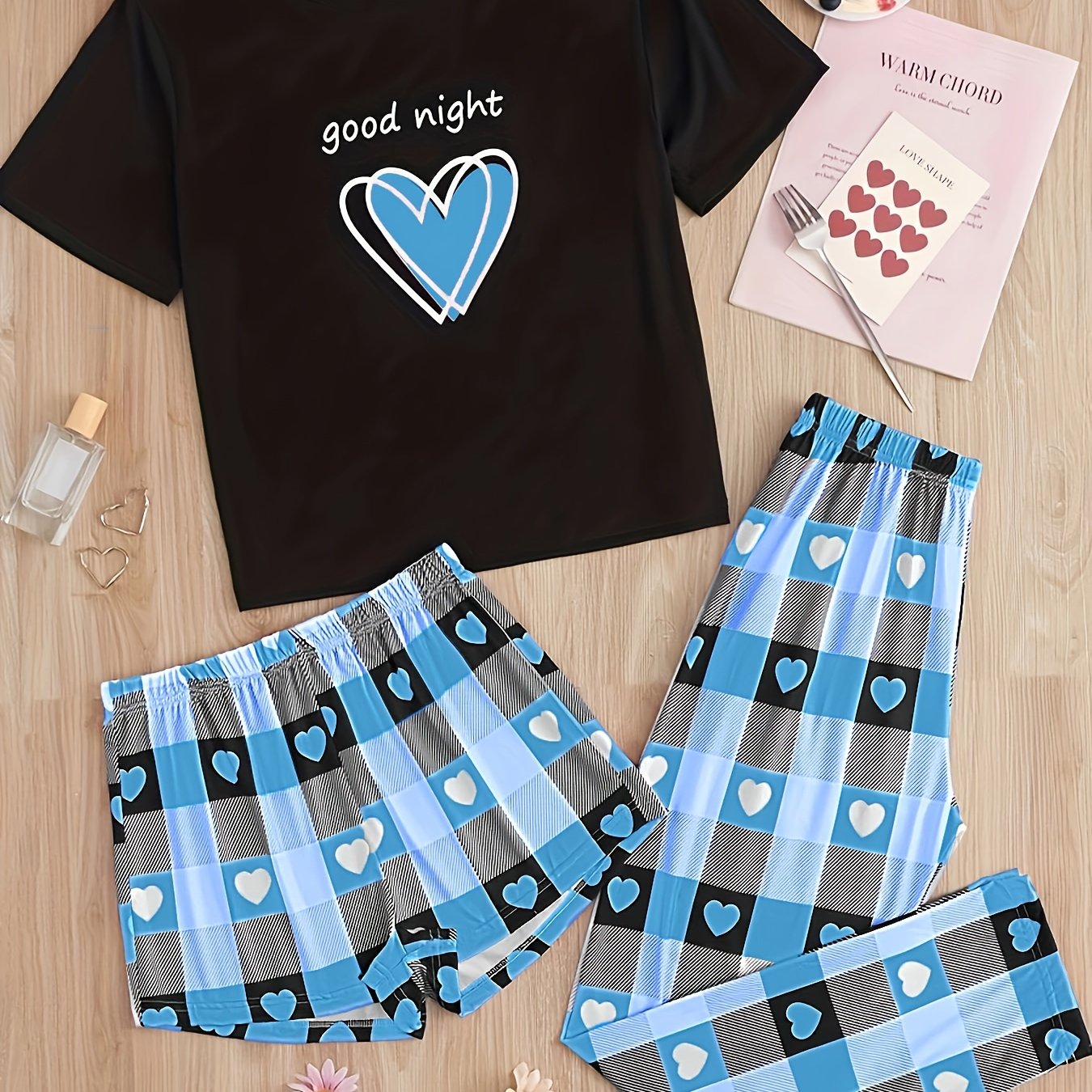 Women's casual pajama set with heart and plaid print, slogan, short sleeve top, and relaxed fit.