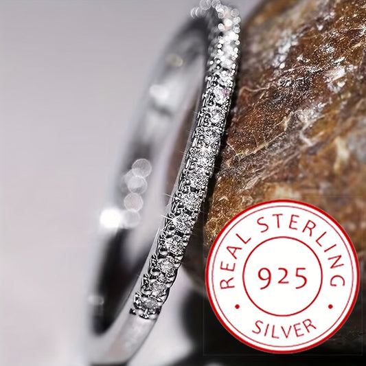 A stunning 925 Sterling Silver ring adorned with a sparkling line of zirconia. This high-quality engagement or wedding ring is the perfect gift for your beloved.