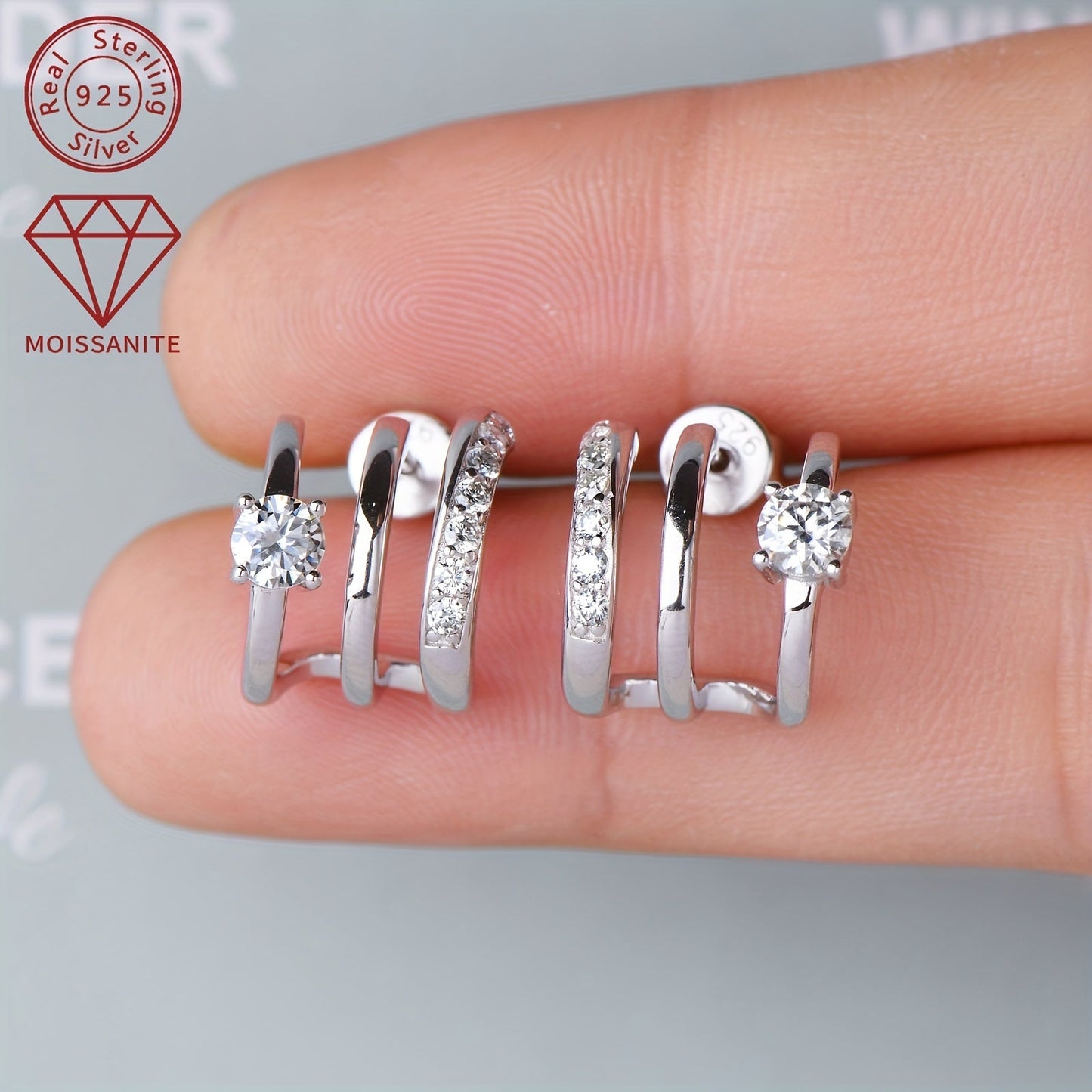 These stunning Moissanite earrings feature a total weight of 4.09g and are set with 4mm*2pcs, 1.6mm*14pcs, and 0.42ct*2pcs Moissanite stones. Crafted from 925 Sterling Silver, these Women's Fashion Half-Open Three-Ring Earrings are designed as a pair and