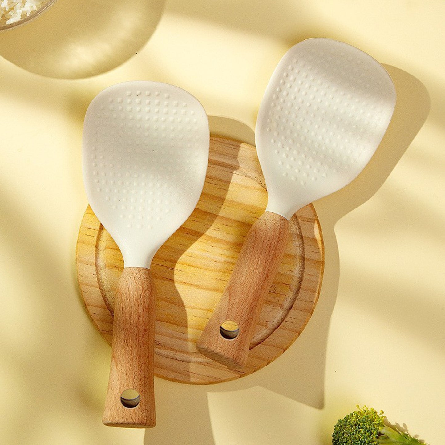 Silicone rice spoon with wooden handle, ideal for non-stick cookware, durable and convenient serving utensil.