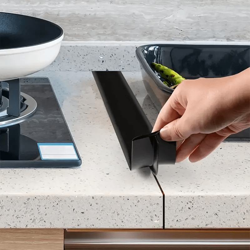 This kitchen stove countertop gap cover is crafted from silicone and features heat-resistant long fillers, perfect for safeguarding the gaps in kitchen cabinets and preventing spills. Ideal for use with a 21-inch stove.