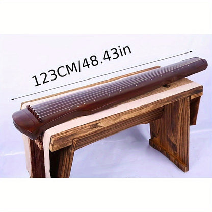 NUNUGGS Traditional Chinese Guqin made of solid paulownia wood with elegant black finish and golden tone tuning pins. Suitable for beginners, photo props, and antique interpretation.