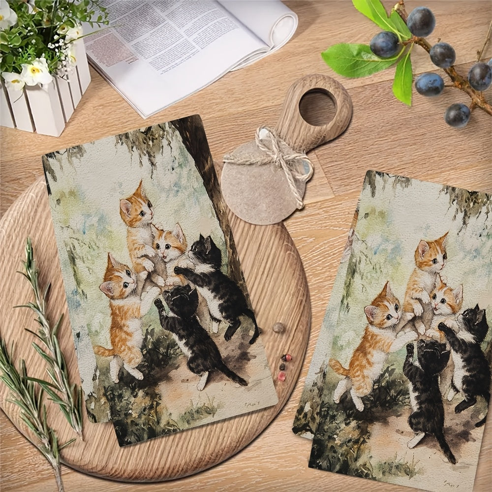 Two ultra plush kitchen towels featuring a playful kittens design. These highly absorbent towels are machine washable and measure 40.64x60.96 cm. Perfect for adding a touch of holiday charm to your kitchen decor and suitable for everyday use as dish