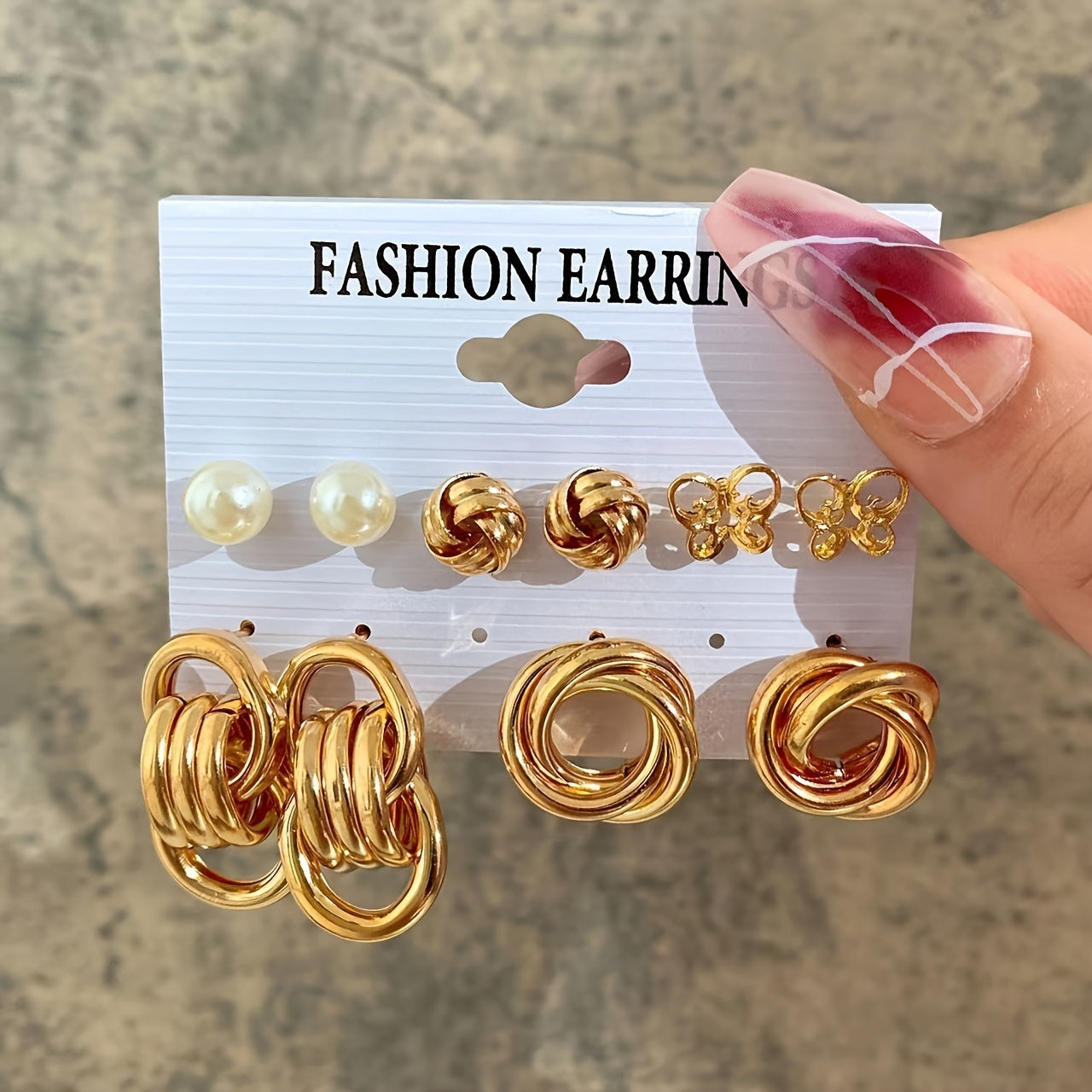 A stunning 10-piece vacation set featuring simple yet exaggerated European and American metal style. These Butterfly Twist Polygon Imitation Pearl Earrings are perfect for women who want to stand out at any party, travel adventure, or holiday getaway.