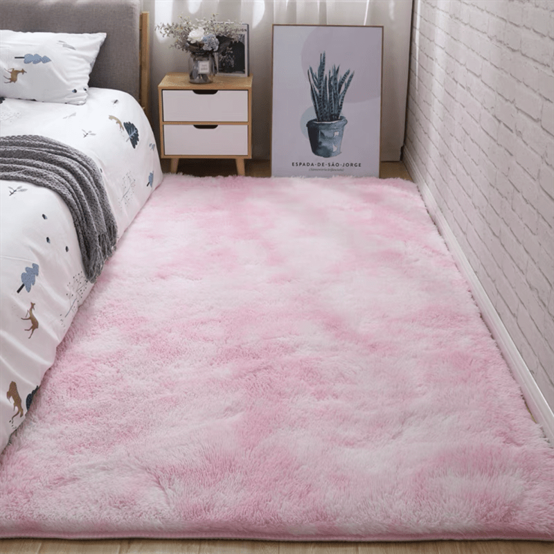 Soft fluffy area rug for bedroom, featuring a non-slip fuzzy shag plush design. This shaggy bedside rug is perfect for girls, kids, babies, teens, and dorm rooms. The tie-dyed pattern adds a fun touch to any living room or nursery. Measures 31.5*62.99