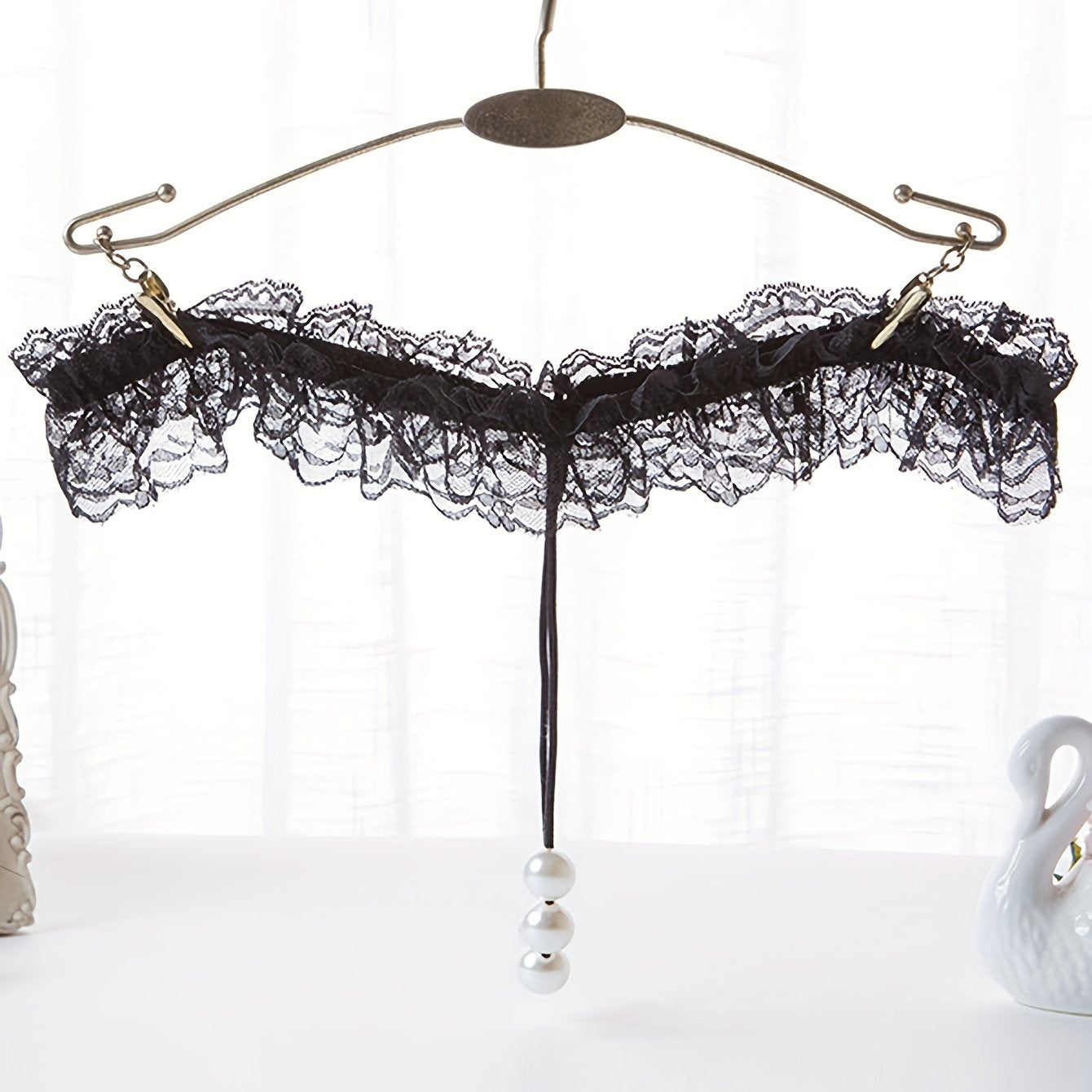 Sexy lingerie for women featuring lace faux pearl bead decoration T-string thongs.