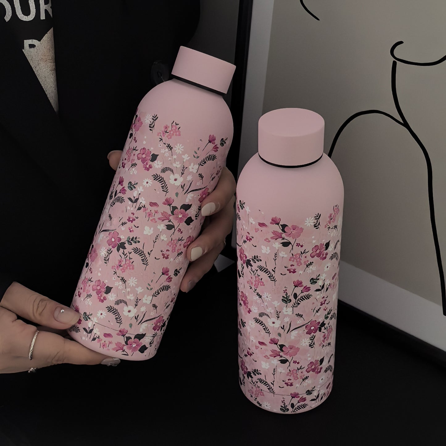 Stylish 16.9oz insulated water bottle with chic pink floral design, perfect for travel, sports, and everyday use. Great gift for birthdays and holidays.