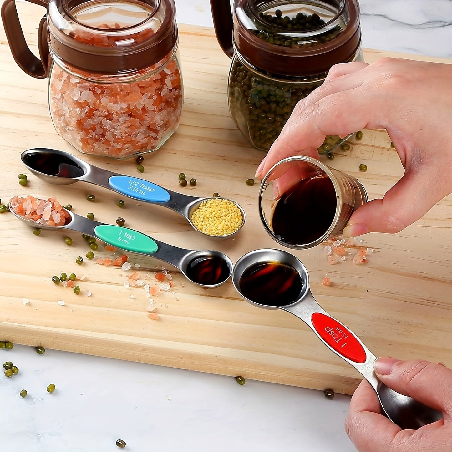 The 23-piece Black Stainless Steel Measuring Cups and Spoons Set includes 8 stackable measuring cups, 8 double-sided magnetic measuring spoons, 1 level, 5 mini spoons, and 1 conversion table. Perfect for measuring both dry and liquid ingredients.