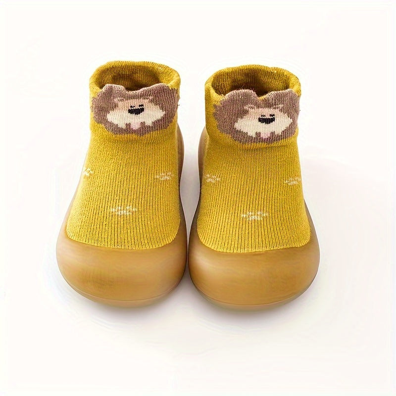 Cute lion cartoon slip-on sock shoes for baby boys in light blue with yellow accents. Soft, breathable, and non-slip rubber sole, perfect for first walkers in spring and fall.