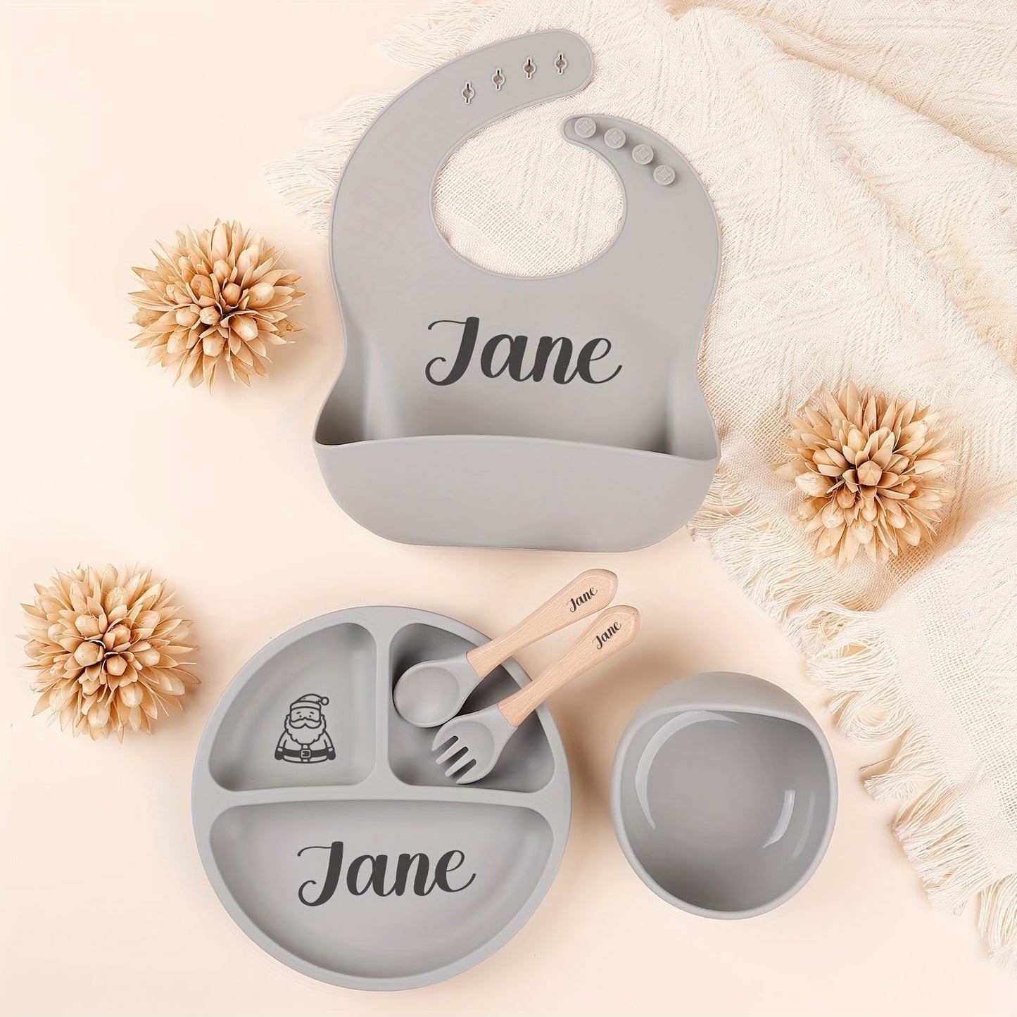 Personalize your child's mealtimes with our Customizable Feeding Set! This set includes a silicone weaning plate with your child's name and a fun cartoon design, along with a spoon, fork, and bowl. It makes the perfect shower gift for new parents.